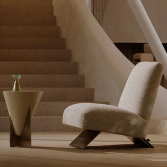 Distinctive Visionnaire Aries lounge chair upholstered in textured neutral beige fabric with polished brass and marble detailing