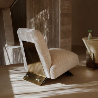 Distinguished Visionnaire Aries lounge chair upholstered in textured neutral beige fabric with sculpted brass and marble accents