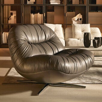 Distinguished Visionnaire Aura lounge chair with sculpted wooden shell upholstered in medium-brown leather and satin metal swivel base