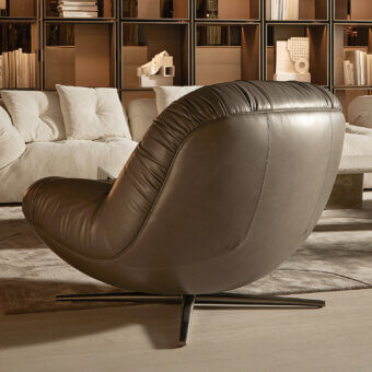 Exceptional Visionnaire Aura lounge chair with sculpted wooden shell upholstered in smooth medium-brown leather and satin metal swivel base