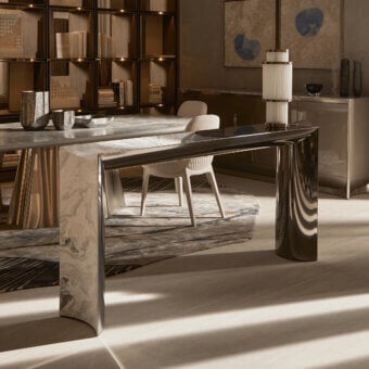 Distinguished Visionnaire Ekos console crafted from cool grey solid marble with polished stainless steel accents and a delicate smoked glass service top