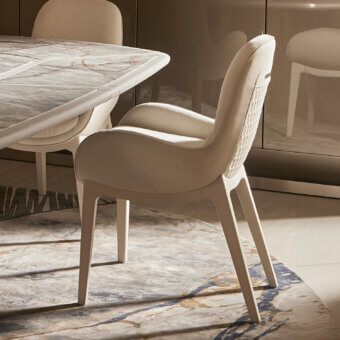 Superior Visionnaire Opus armchair with light beige textile upholstery and curved cylindrical bands with patterned stitching