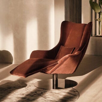 Distinguished Visionnaire Selfless lounge chair with reddish-brown fabric upholstery and polished steel swivel base