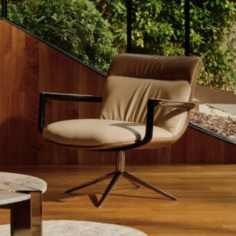 Distinguished Visionnaire Spectre lounge chair with lavish leather backrest and neutral beige textile seat supported by polished stainless steel base