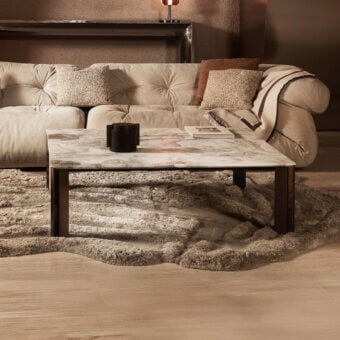 Elegant Visionnaire Vixen coffee table with beige and cream-veined marble top and polished stainless steel with textured aluminum base