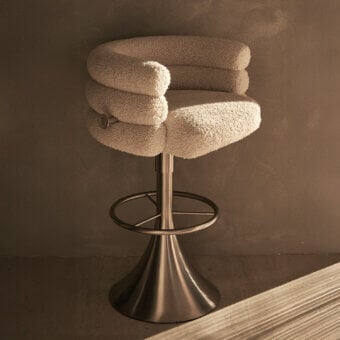 Sophisticated Visionnaire Voluptas stool upholstered in textured neutral beige bouclé with burnished stainless steel and functional swivel base
