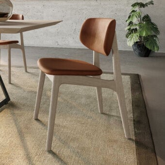 Distinguished Dallagnese Float chair with handcrafted solid ash frame and warm brown leather-like seat, finished with electrostatic coating