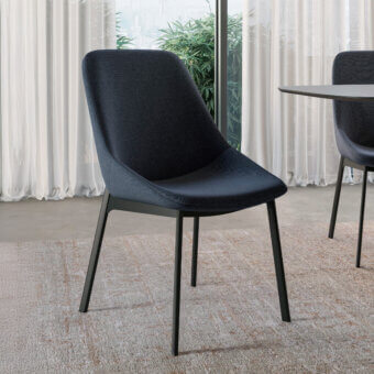 Distinctive Dallagnese Le Mans chair with dark gray-blue quilted fabric and a fixed metal frame built with brass reinforcement