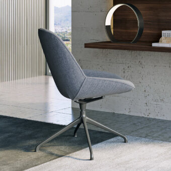 Superior Dallagnese Le Mans chair with enveloping form upholstered in subtly textured gray fabric and satin finish