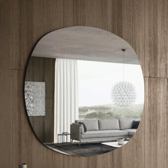 Distinctive Dallagnese Radius mirror crafted in precision glass with a polished-edge finish and subtly asymmetrical form