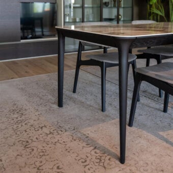 Elegant Dallagnese Smooth table with stone-like top displaying grey and beige veining and sleek dark-toned metal legs