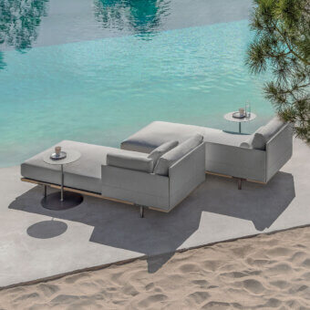Refined Ethimo Baia daybed crafted with fabric upholstery and a wood base in a light gray finish for comfortable outdoor relaxation