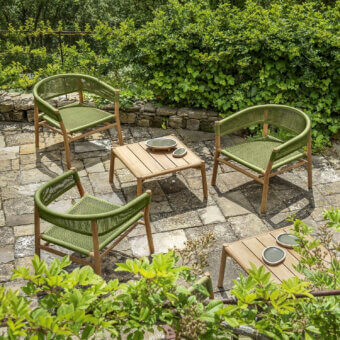Harmonious Ethimo Kilt armchair crafted in FSC-certified teak with a soft natural fibre weave and muted green hue