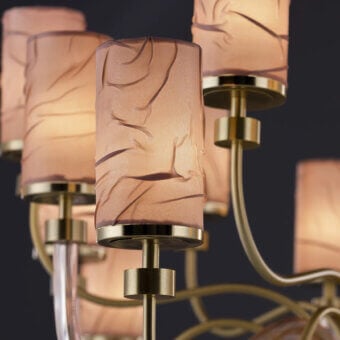 Distinguished Euroluce Dely chandelier crafted in metal with cylindrical lampshades covered in antique pink wrinkled satin and warm gold finish