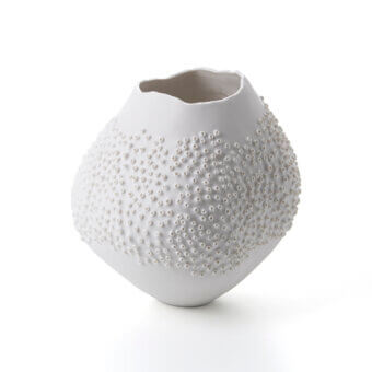 Distinguished FOS Ceramiche Oceania vase crafted in Italian porcelain with a pale gray, textured surface and evocative metal oxides