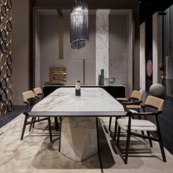 Luxury Giorgetti Amadeus table built with Canaletto walnut and marble, showcasing polished edges with a captivating geometric base