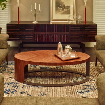 Superior Giorgetti Ling coffee table with curved Canaletto walnut veneer and bronze-painted metal base