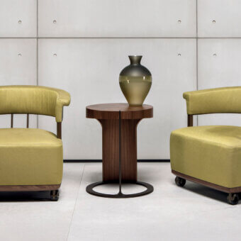 Distinguished Giorgetti Ling coffee table crafted in warm Canaletto walnut veneer with a satin finish and bronze-painted metal base
