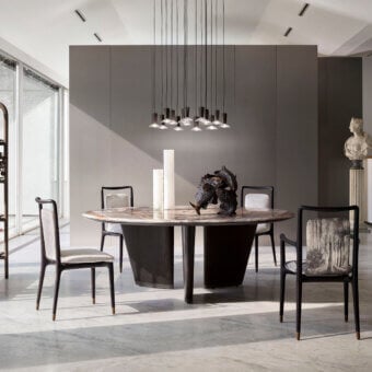 Exceptional Giorgetti Mistral round table with a marble top and bronze insert supported by veneered ash wood with a dark matte finish