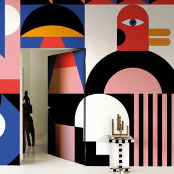 Avant-garde LondonArt Eden wallpaper showcases geometric leaf forms and eye motifs in blues, blacks, reds, and oranges creating a dynamic mural effect