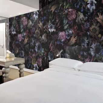 Exceptional LondonArt Rio Wallpaper captures vibrant energy with a bold floral design against a dramatic black background in blues, purples, and greens