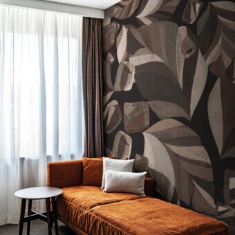 Exceptional LondonArt Skyfall wallpaper displays a graphic botanical design with muted browns, grays, and blacks in a matte finish