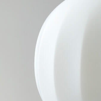 Elegant Luceplan Lita table lamp with rounded form crafted in opaline blown-glass and solid ash wood with uniform white finish