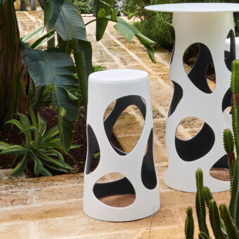 Distinguished MY YOUR Liberty stool in black synthetic material with a smooth matte finish and unique perforated cylindrical form