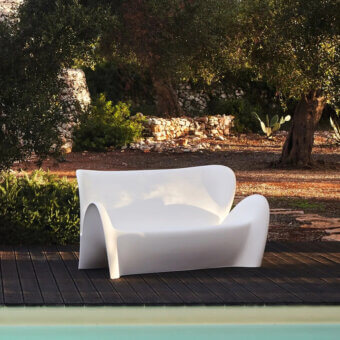 Avant-garde MY YOUR Lily sofa with fluid organic form molded from durable glossy white plastic designed in Italy
