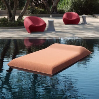 Distinguished MY YOUR Louis floating lounger crafted in textured coral textile offering a buoyant platform for serene outdoor relaxation