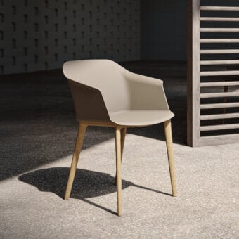 Sophisticated MY YOUR Sofia armchair in neutral beige molded polypropylene with satin-finish wooden legs
