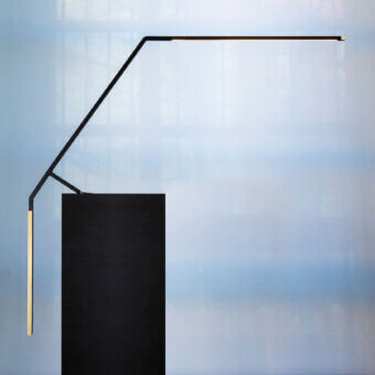 Distinguished Nemo Bird table lamp crafted in Italy with matte black metal and satin gold counterweight offering balanced illumination