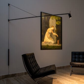 Exceptional Nemo Lighting Swan wall lamp crafted in matte black metal with refined leather counterweight and precise directional control