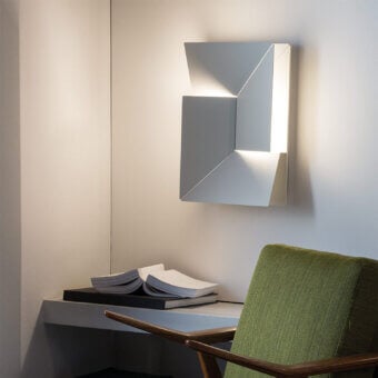 Architectural Nemo Lighting Wall Shadows wall lamp crafted with laser-cut aluminum in matte white finish emitting diffused LED glow