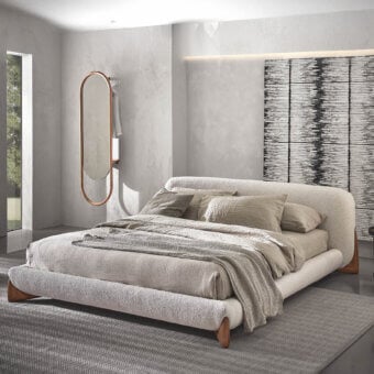 Distinguished Porada Softbay bed crafted in textured beige textile with solid Canaletta walnut wood end-feet for a sophisticated form