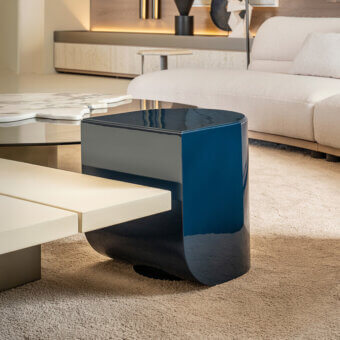 Distinguished Shake Blend side table with gently curved form and deep blue veneer wood structure with varnished steel base