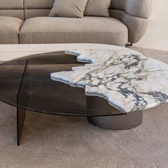 Exceptional Shake Capri coffee table with honed white marble and transparent tempered glass atop a dark muted-tone metal base