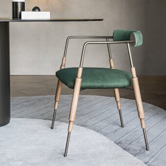 Exceptional Shake Frame armchair with varnished steel, solid ash wood legs, and deep green leather upholstery