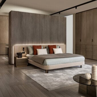 Distinguished Shake Line bed with muted beige-grey textile upholstery and slim varnished steel legs crafted in Italy