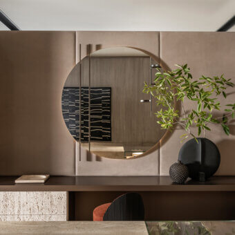 Elegant Shake Line mirror with sleek circular form and warm brown matte wood frame crafted in polished varnished steel