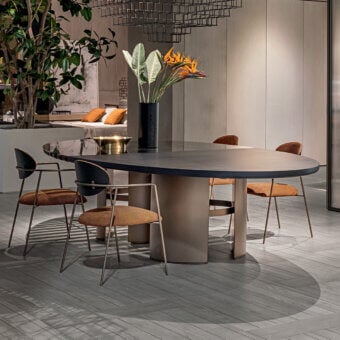 Distinguished Shake Tal table with a round dark charcoal top blending blockboard, solid ash wood, and polished-edge tempered glass with a varnished steel base