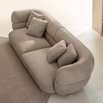 Exceptional Shake Vogue sofa with organically curved form upholstered in matte beige textile and varnished steel legs