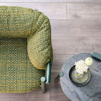 Sophisticated Varaschin Allegra lounge chair with a rounded form and woven green and yellow fabric upholstery with a matte finish