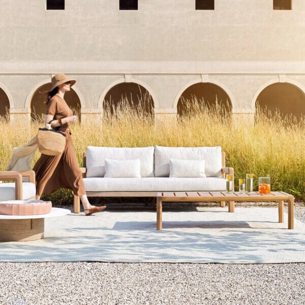 Refined Varaschin Gianna sofa crafted with aluminum and Iroko wood, featuring light beige cushions with a Desert woven seat base