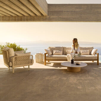 Elegant Varaschin Gianna sofa with woven textile and Iroko wood sides, built with a durable aluminum structure in neutral beige and Desert shades