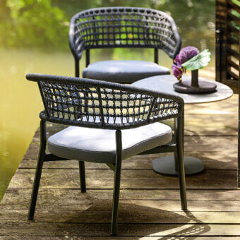 Distinguished Varaschin Plinto armchair with woven seat and backrest in dark gray powder-coated aluminum, built with a plush gray cushion