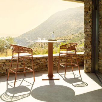 Distinguished Varaschin Plinto bar stool with reddish-brown powder-coated aluminum and light beige woven textile seat