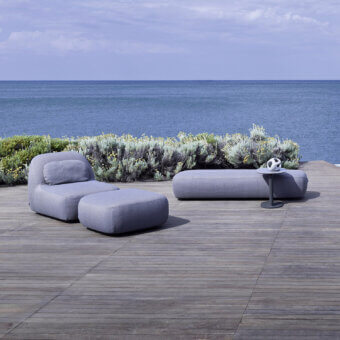 Elegant Varaschin Reuse outdoor sofa built with okumè wood and textured hemp fabric in a muted gray tone