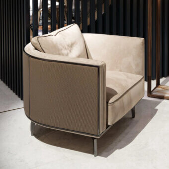Exceptional Visionnaire Backstage lounge chair with curved wooden shell upholstered in light beige textile and woven taupe leather with satin brass profile