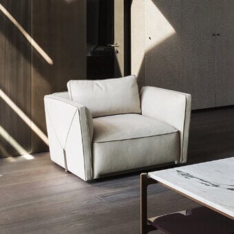 Superior Visionnaire Bastian Still lounge chair with muted off-white textile upholstery and satin steel accents